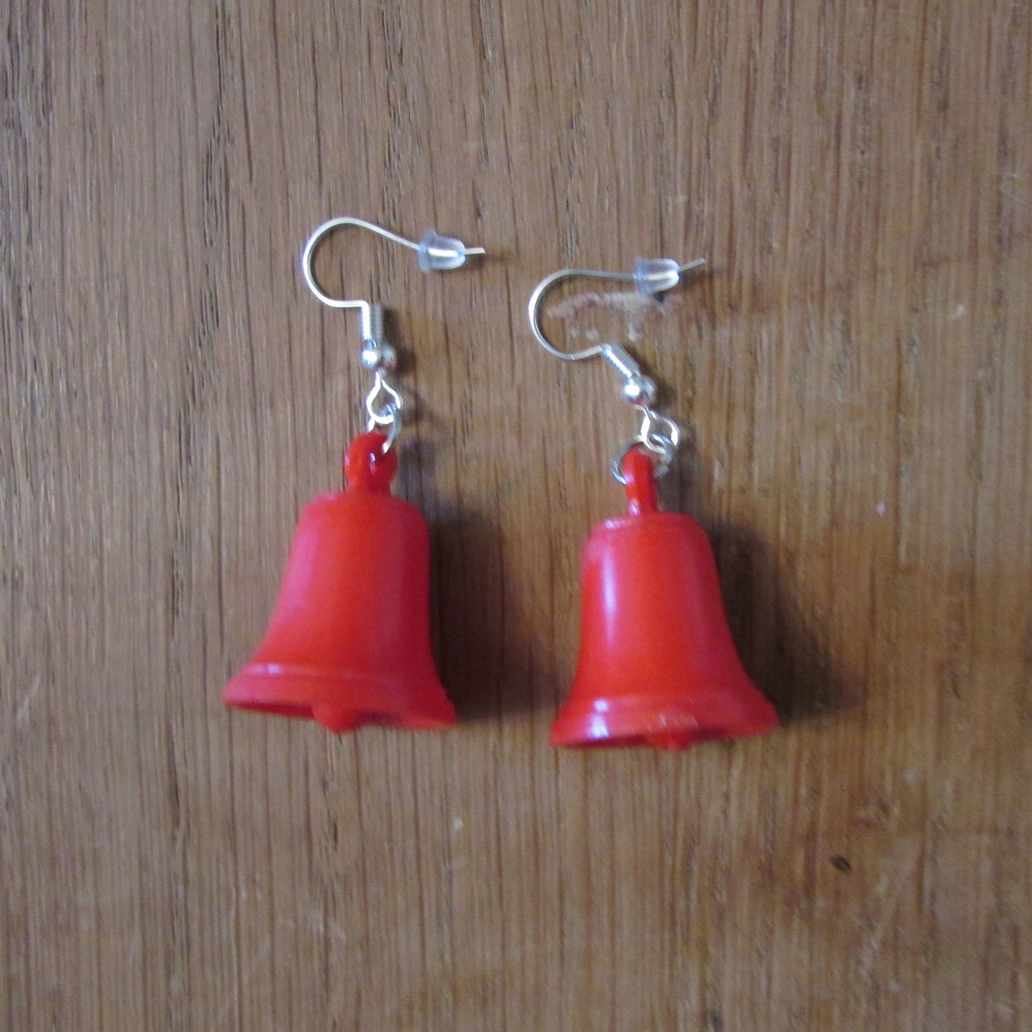 Kitsch home-made earrings made using vintage plastic bell cake toppers