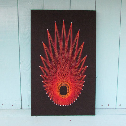Home-made "Starburst" string art made from original 1973 pattern, black background