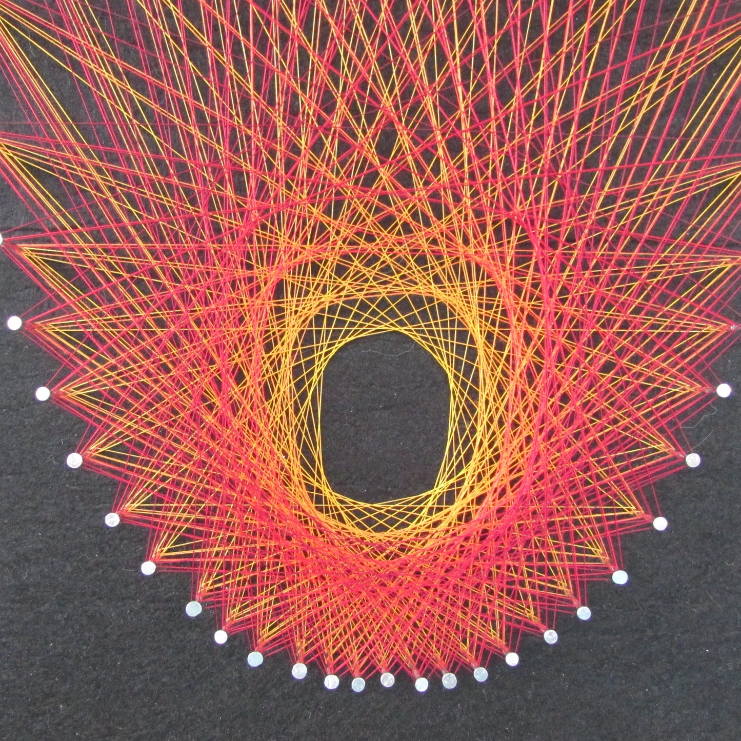 Home-made "Starburst" string art made from original 1973 pattern, black background