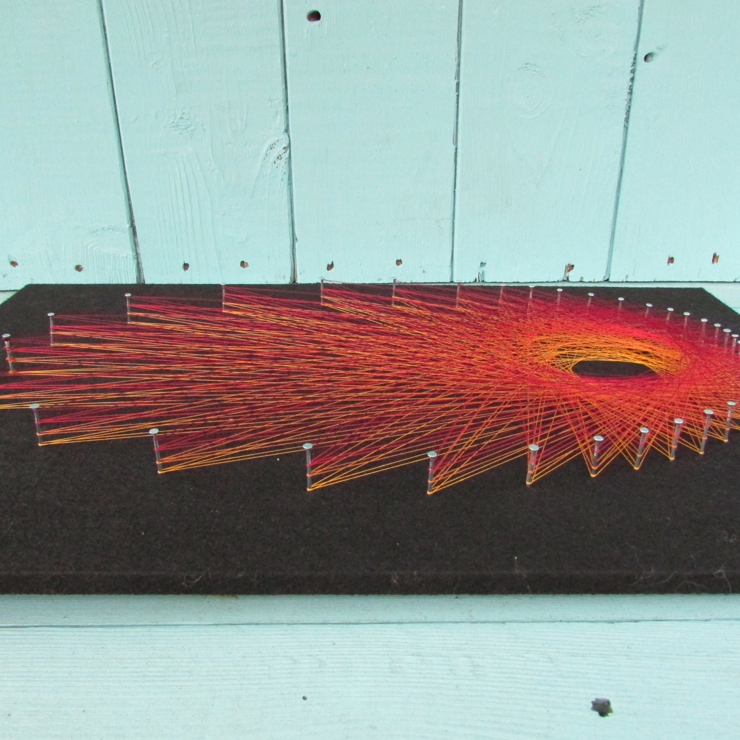 Home-made "Starburst" string art made from original 1973 pattern, black background