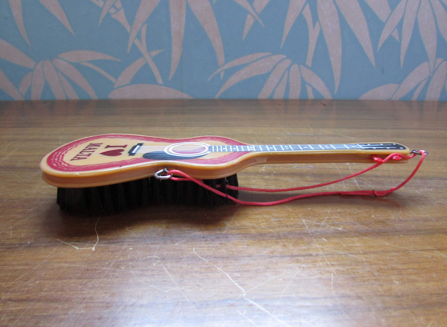 1970s/80s "I Love Malta" plastic guitar-shaped clothes/hair brush