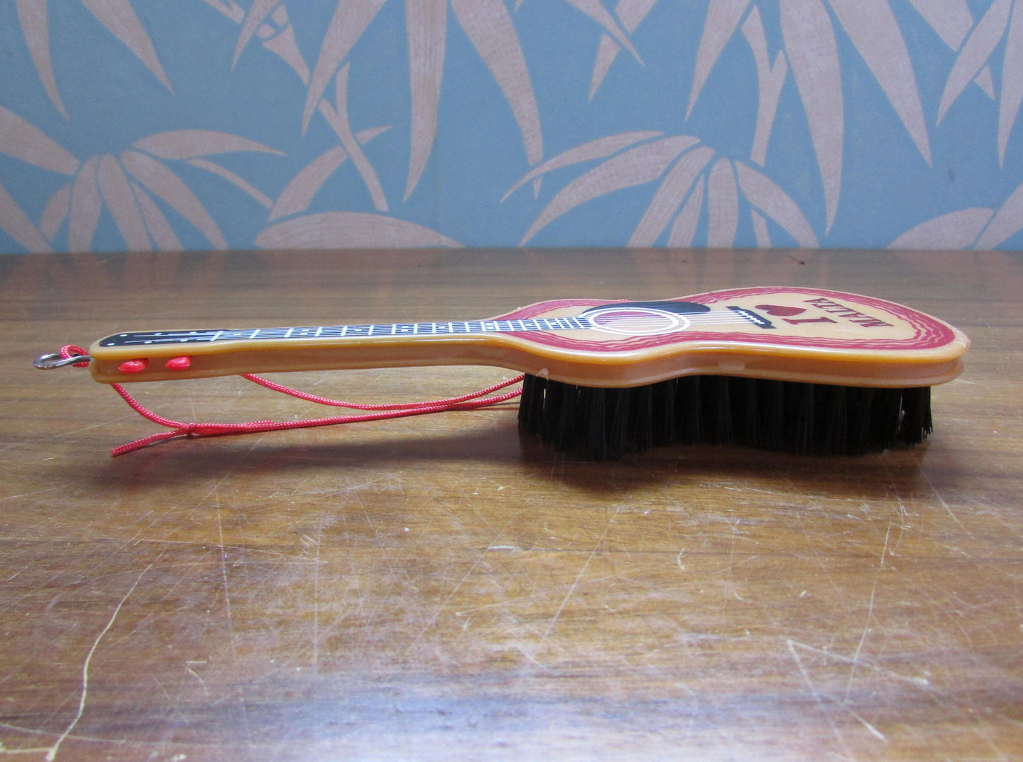 1970s/80s "I Love Malta" plastic guitar-shaped clothes/hair brush