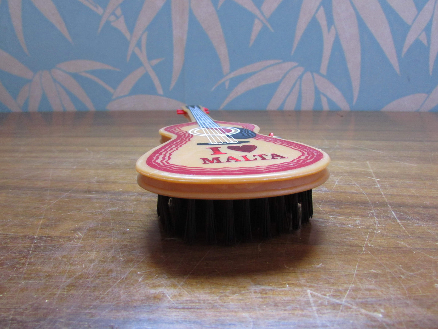 1970s/80s "I Love Malta" plastic guitar-shaped clothes/hair brush