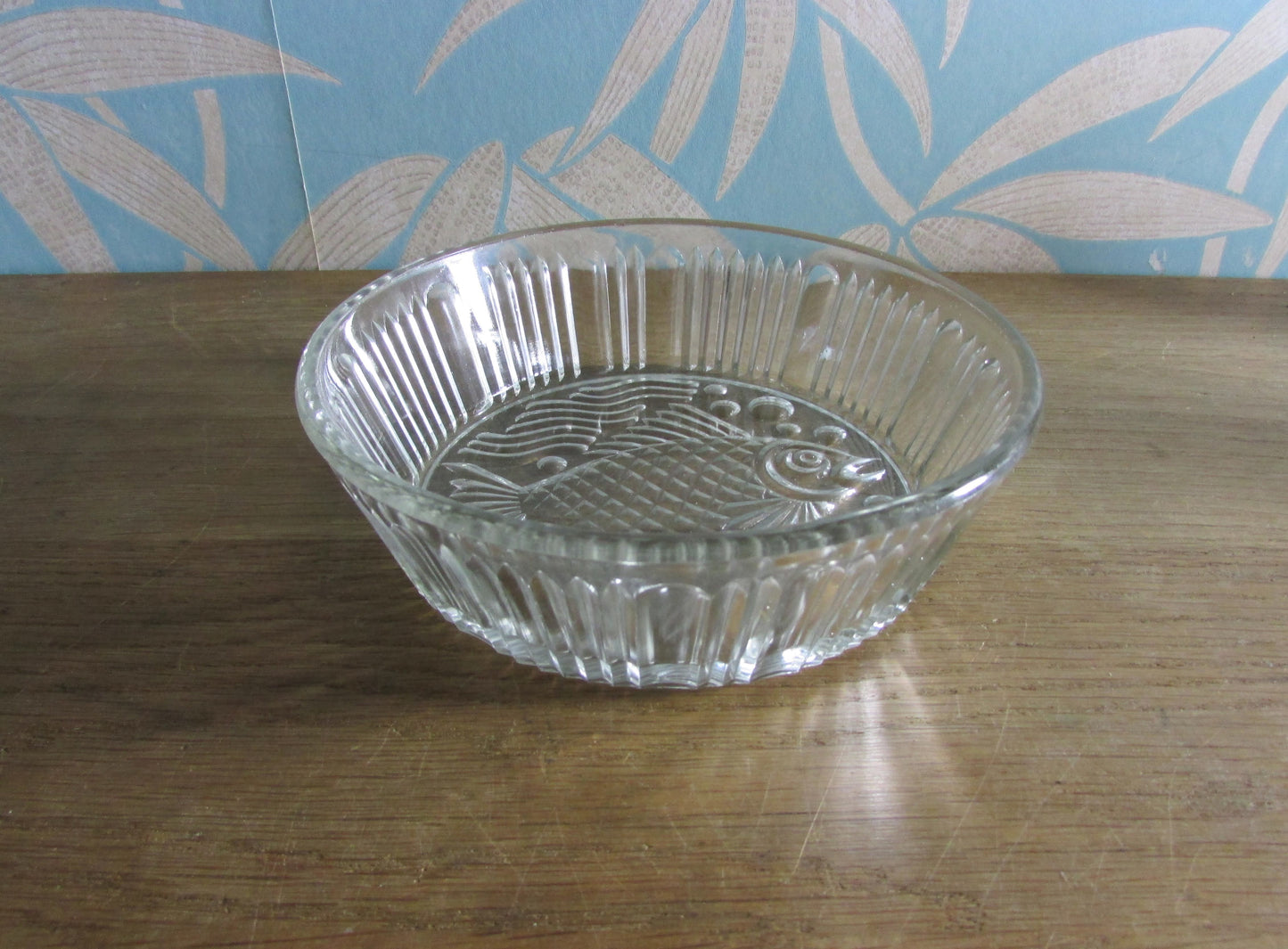 Vintage pressed glass bowl with fish ornamentation