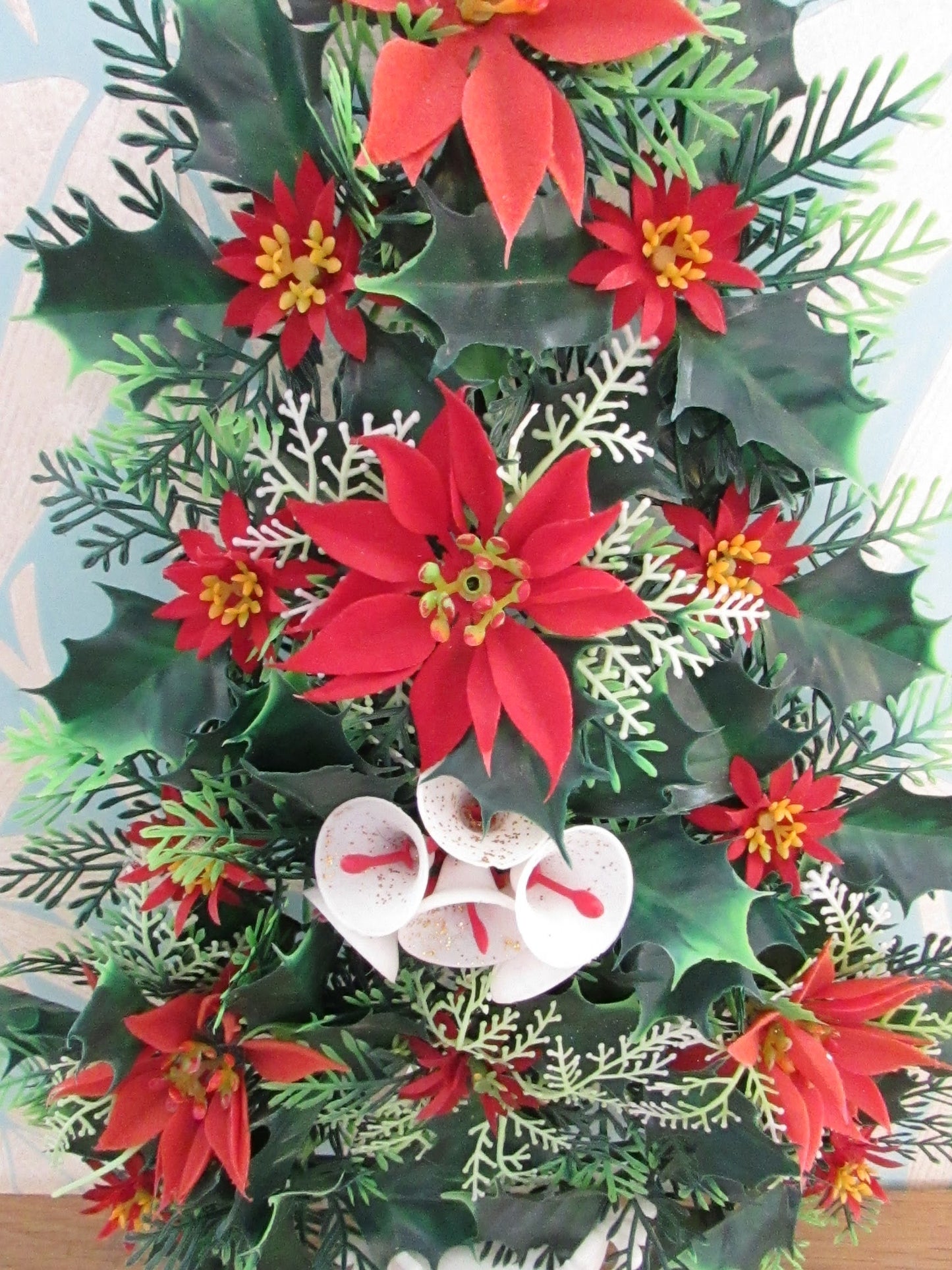 1970s plastic miniature wall-hanging Christmas tree festooned with Poinsettia