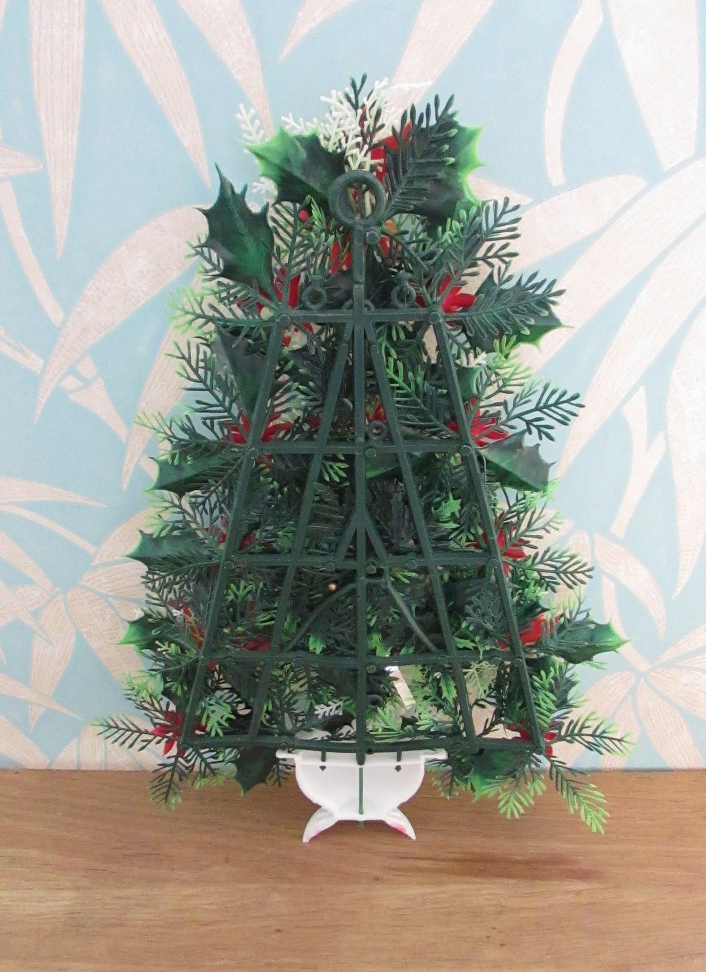 1970s plastic miniature wall-hanging Christmas tree festooned with Poinsettia