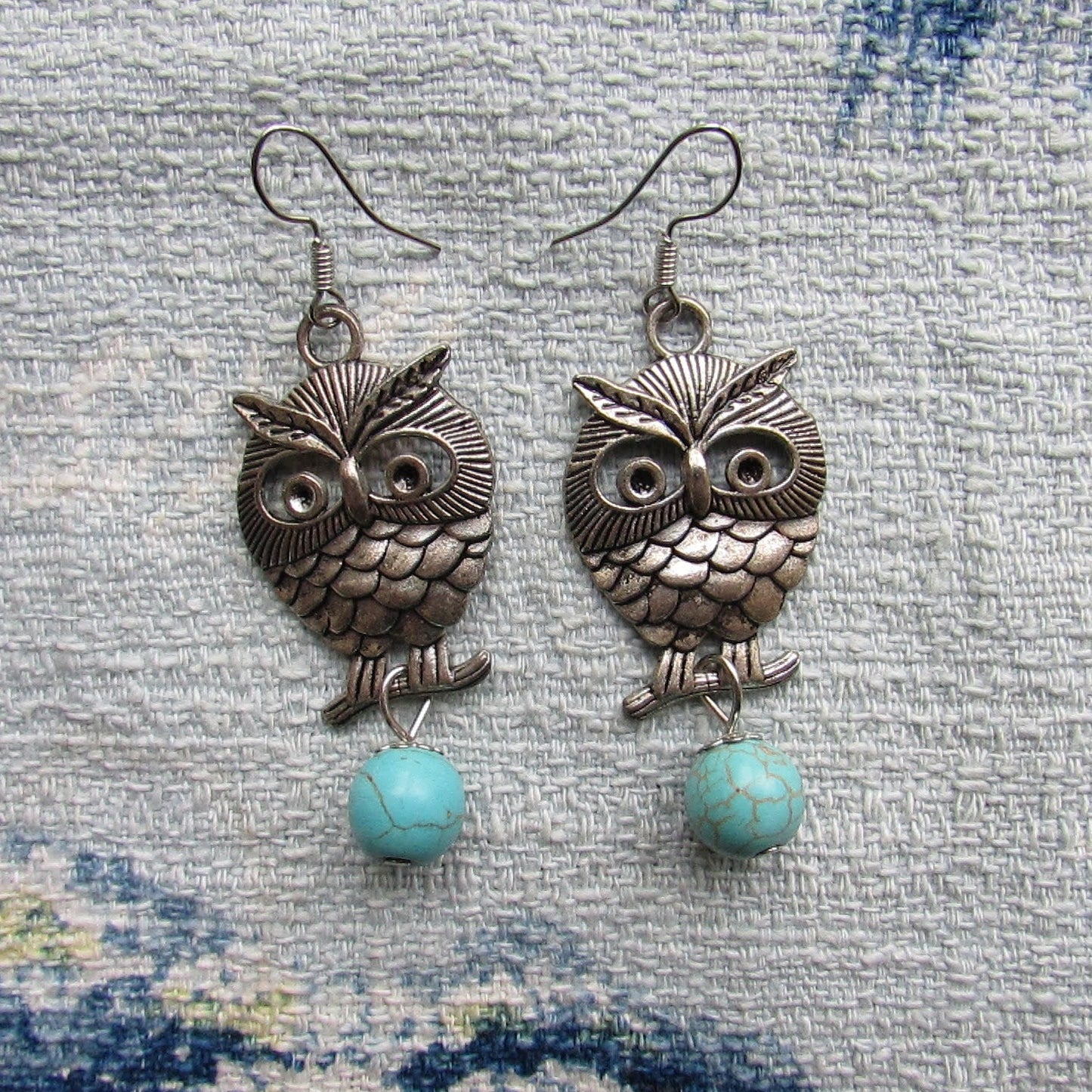 circa. 1990s silver-tone owl drop earrings with turquoise stone