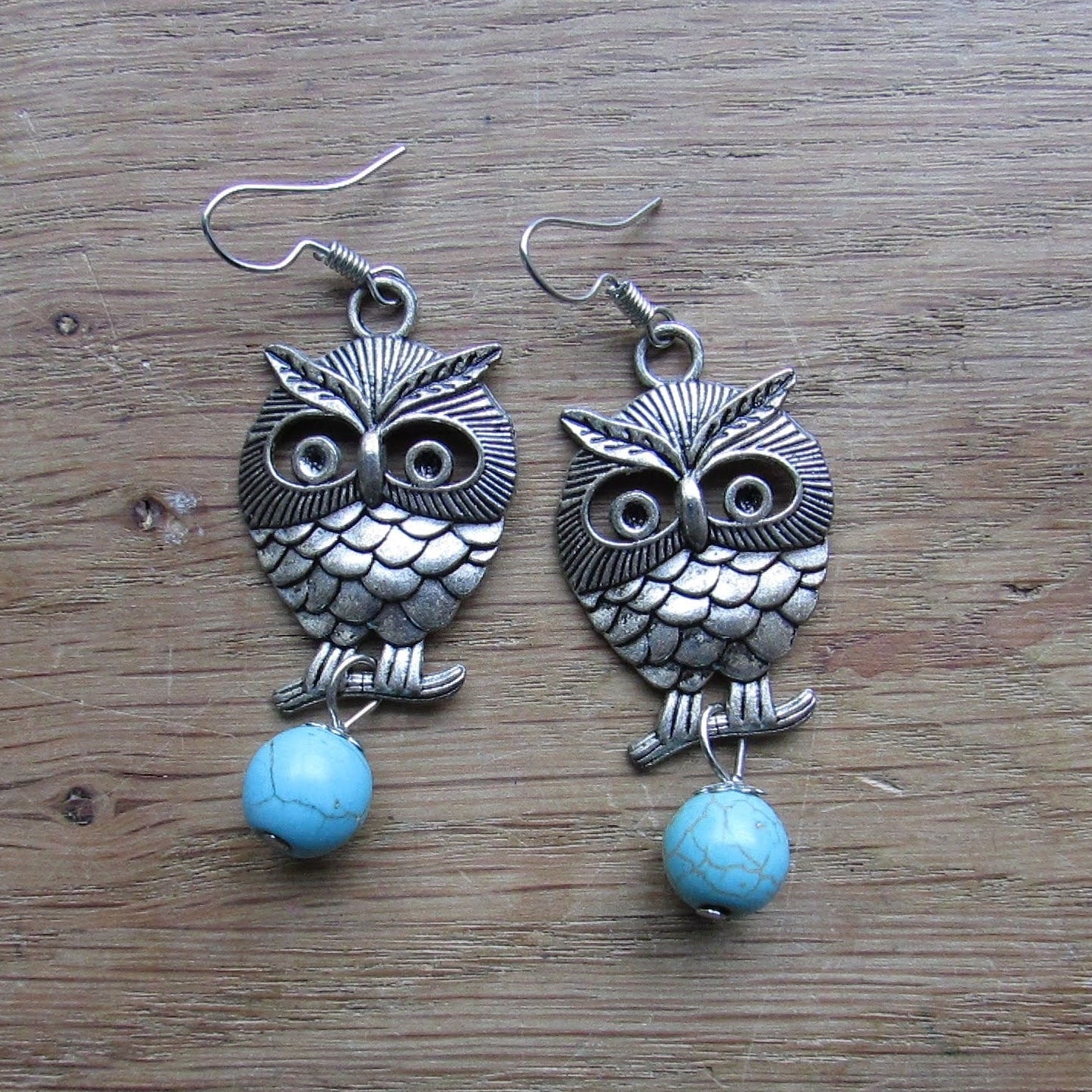 circa. 1990s silver-tone owl drop earrings with turquoise stone