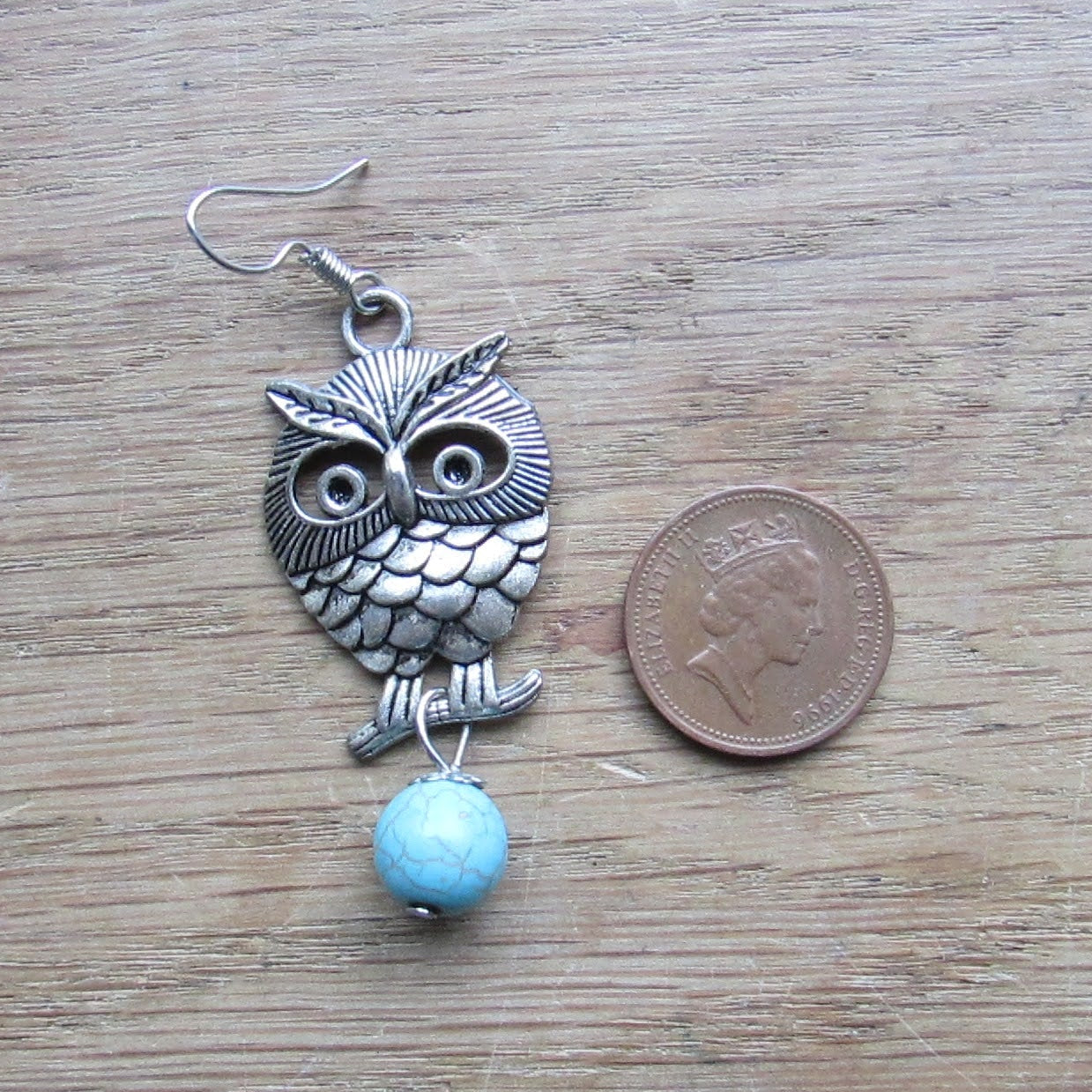 circa. 1990s silver-tone owl drop earrings with turquoise stone