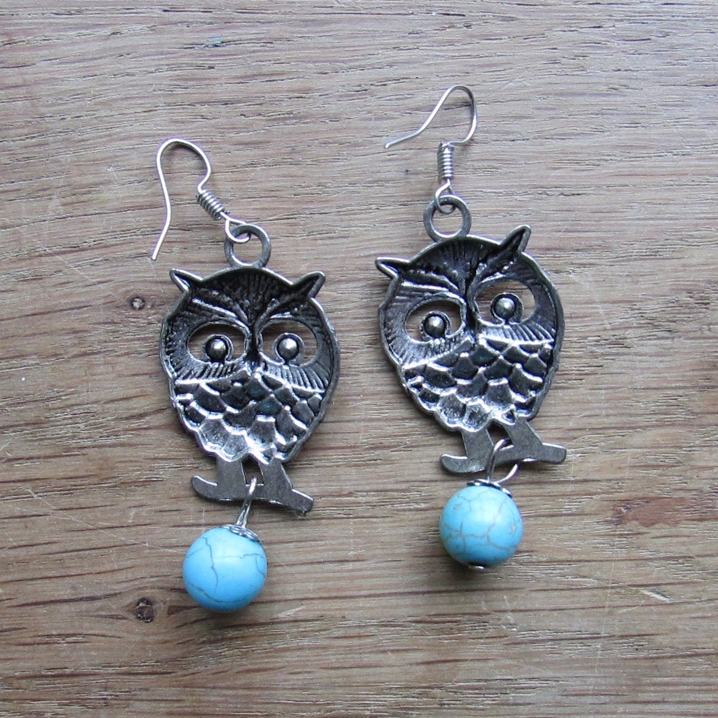 circa. 1990s silver-tone owl drop earrings with turquoise stone