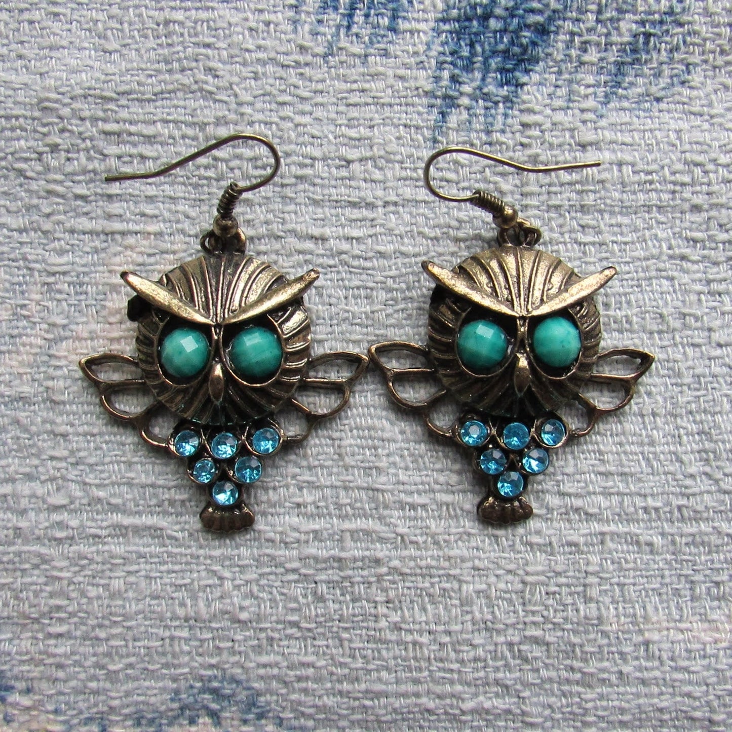 1980s gold-tone owl drop earrings with green cabochon eyes & turquoise rhinestone detail