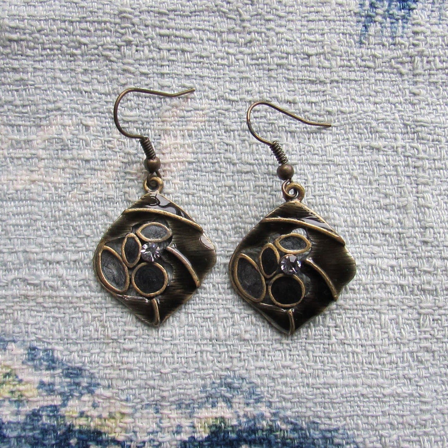 1970s/80s brass-tone abstract drop earrings with black enamel and rhinestone detail