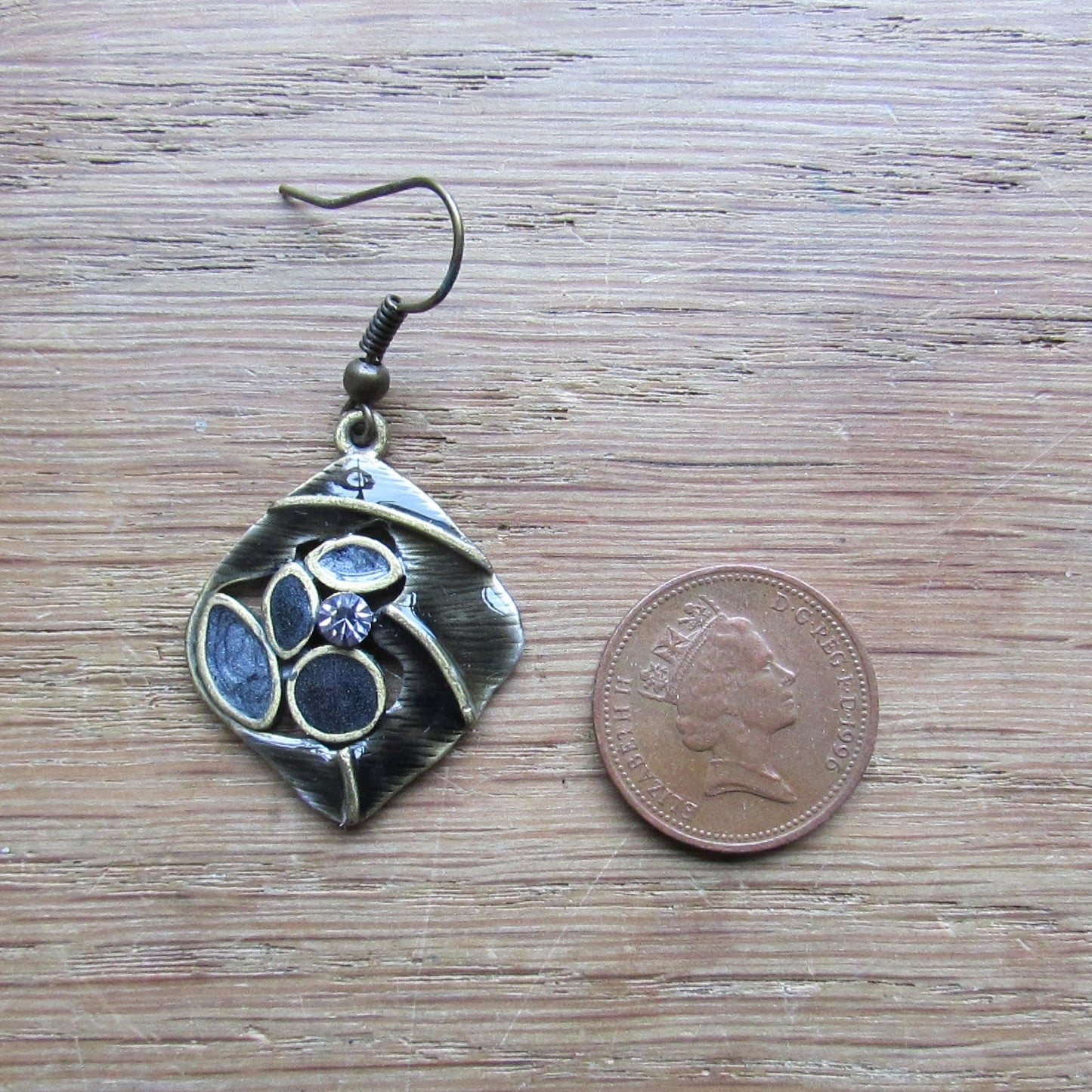 1970s/80s brass-tone abstract drop earrings with black enamel and rhinestone detail