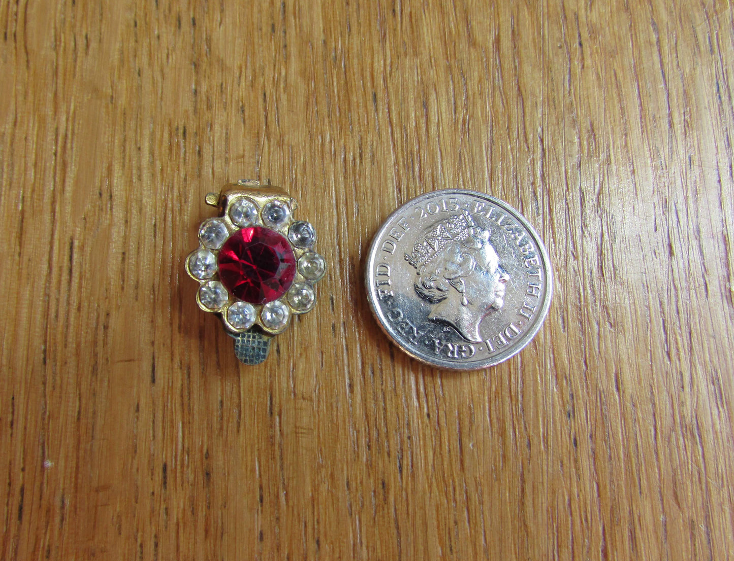 Small mid-century gold-tone clip on earrings with ruby red central glass surrounded by diamanté