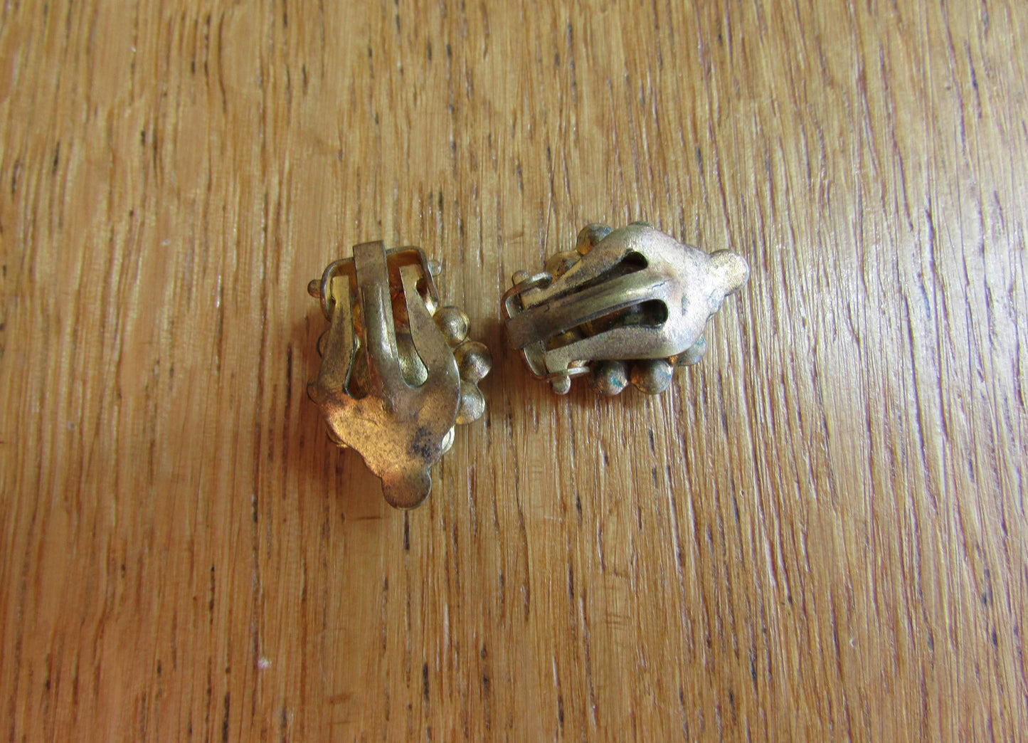 Small mid-century gold-tone clip on earrings with ruby red central glass surrounded by diamanté