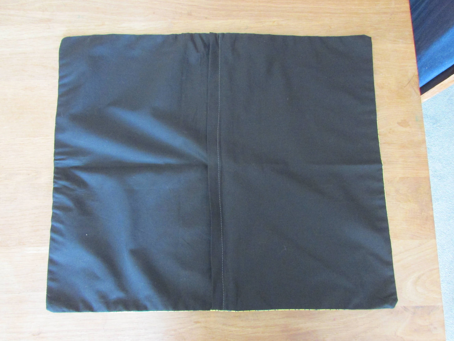 Home-made 1950s yellow & back abstract pattern cushion cover with contrast black reverse