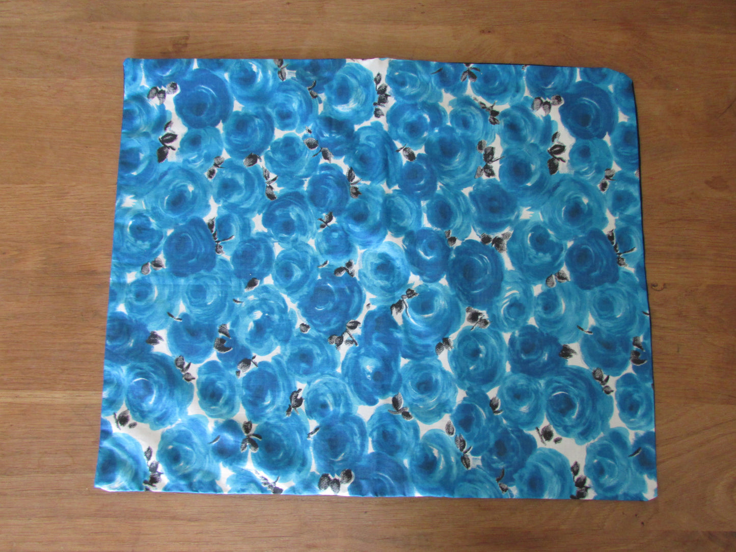 Home-made mid-century blue repeat rose cushion cover with contrast black reverse