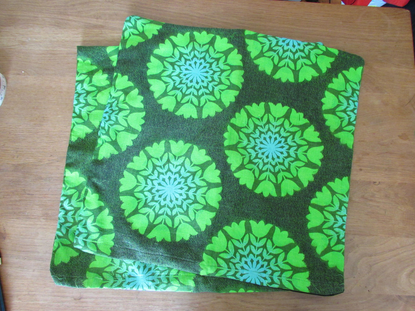 Home-made vintage green tulips circles cushion cover with contrast black reverse