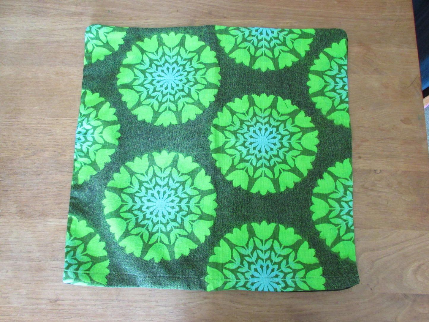 Home-made vintage green tulips circles cushion cover with contrast black reverse