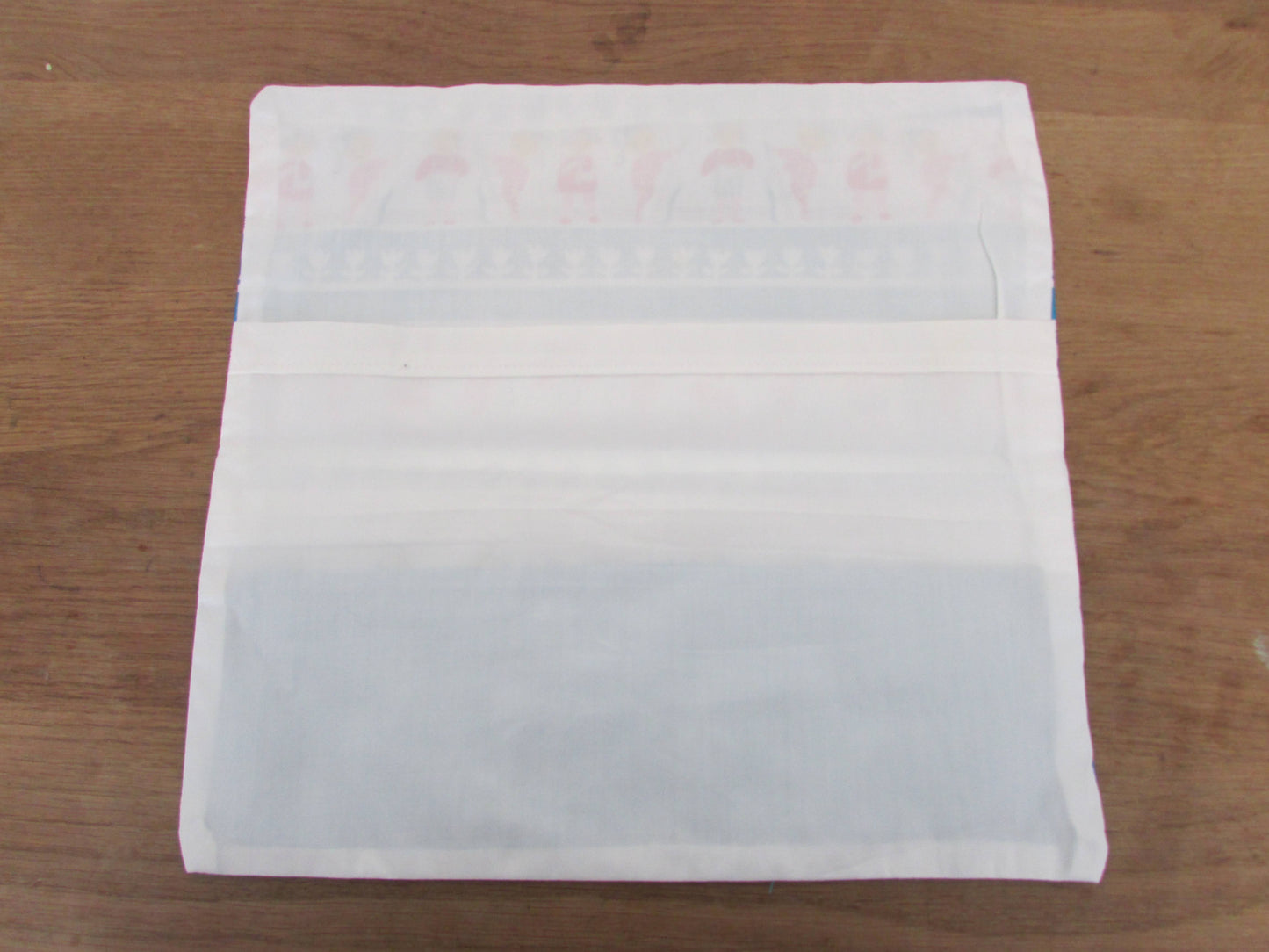 Home-made vintage-style nursery cushion cover depicting pony-tailed girls playing musical instruments, with contrast white reverse