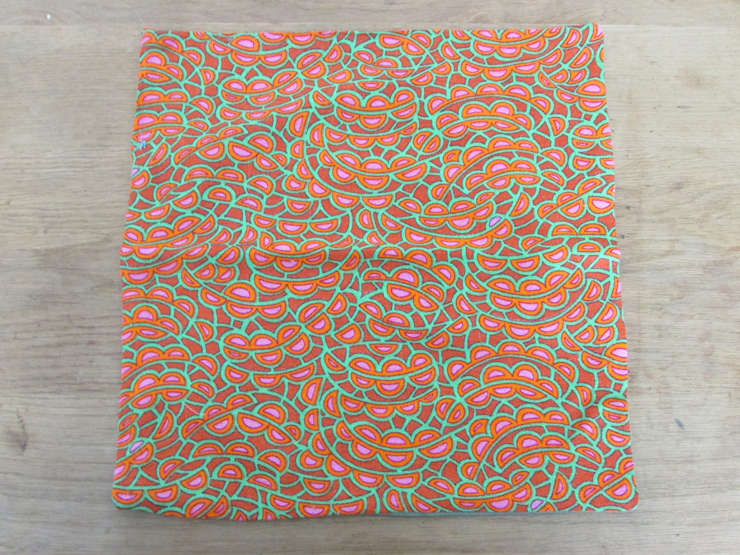 Home-made 1970s orange/pink/green pattern cushion cover with contrast green reverse