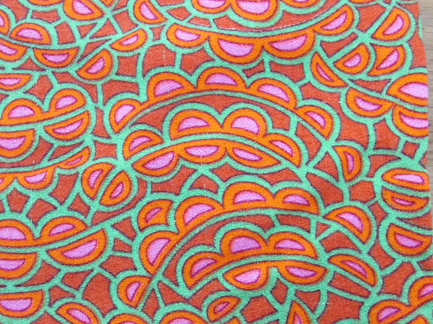 Home-made 1970s orange/pink/green pattern cushion cover with contrast green reverse