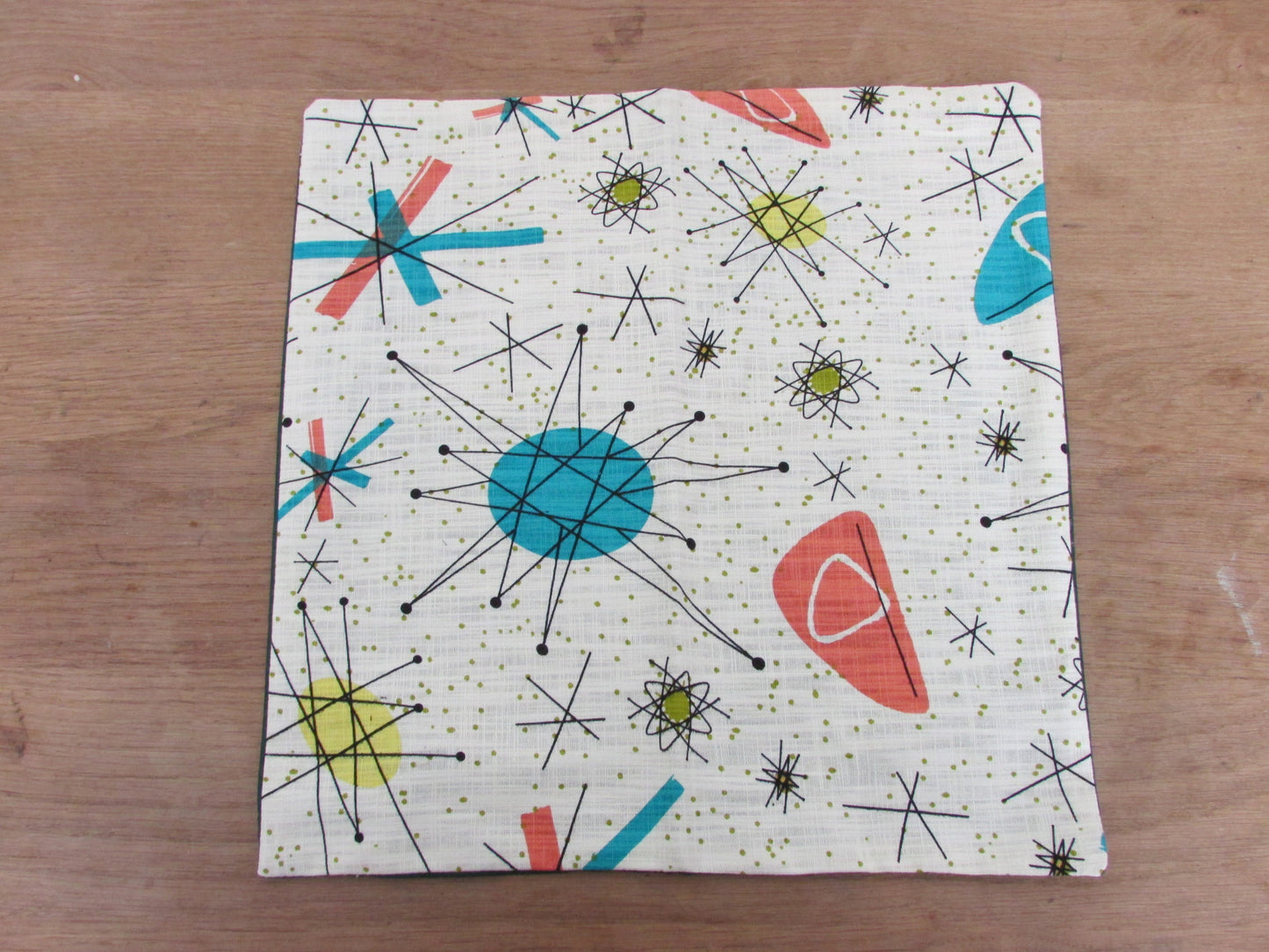 Home-made 1950s-inspired Atomic Starburst pattern cushion cover with contrast green OR rust reverse
