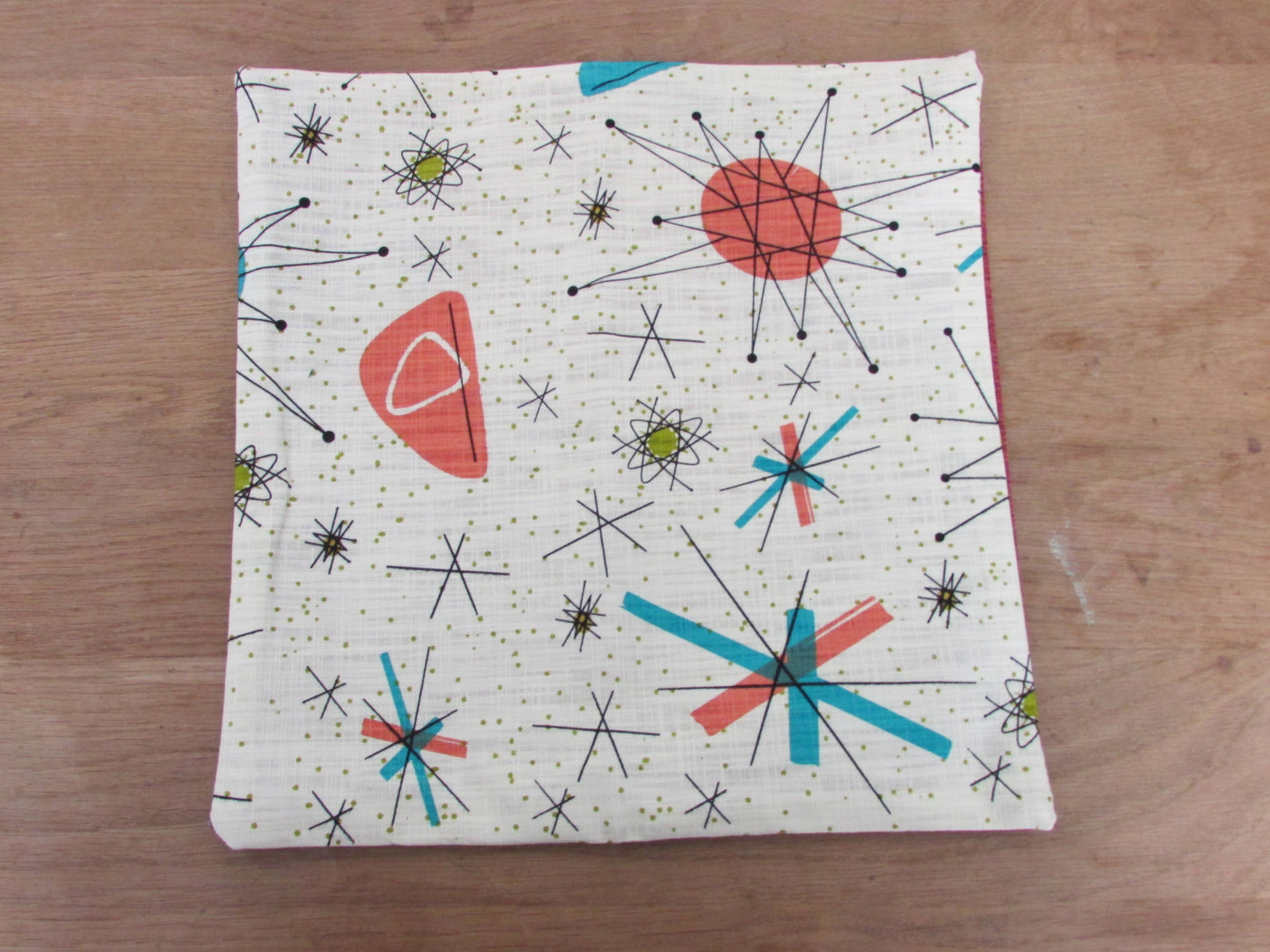 Home-made 1950s-inspired Atomic Starburst pattern cushion cover with contrast green OR rust reverse