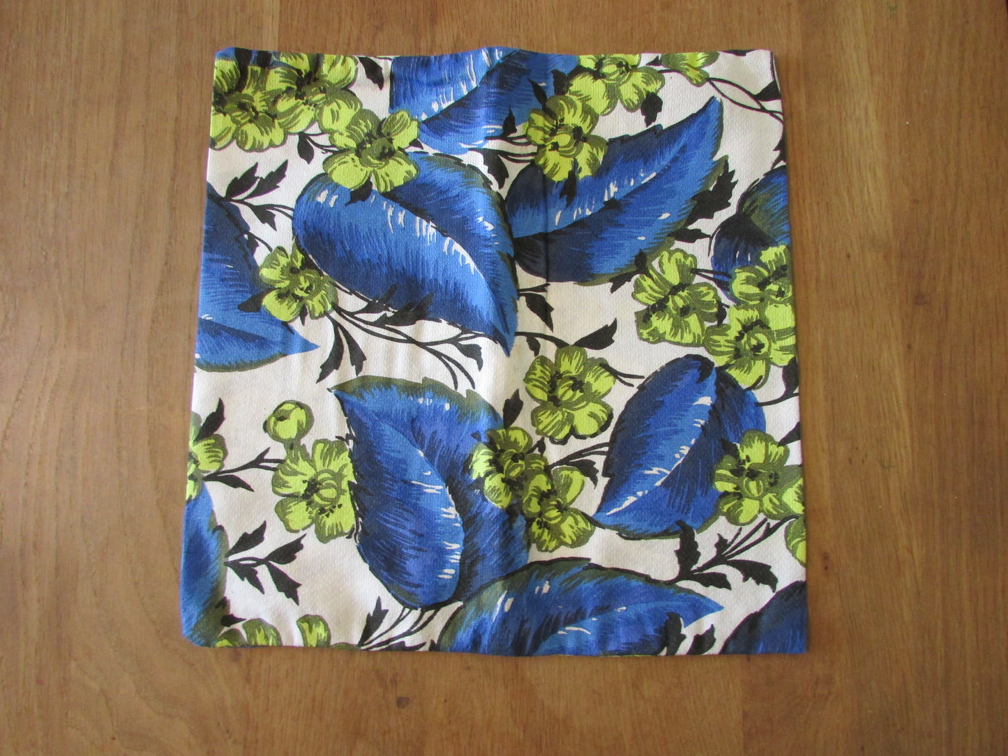 Home-made vintage bright blue leaf pattern cushion cover with same pattern reverse
