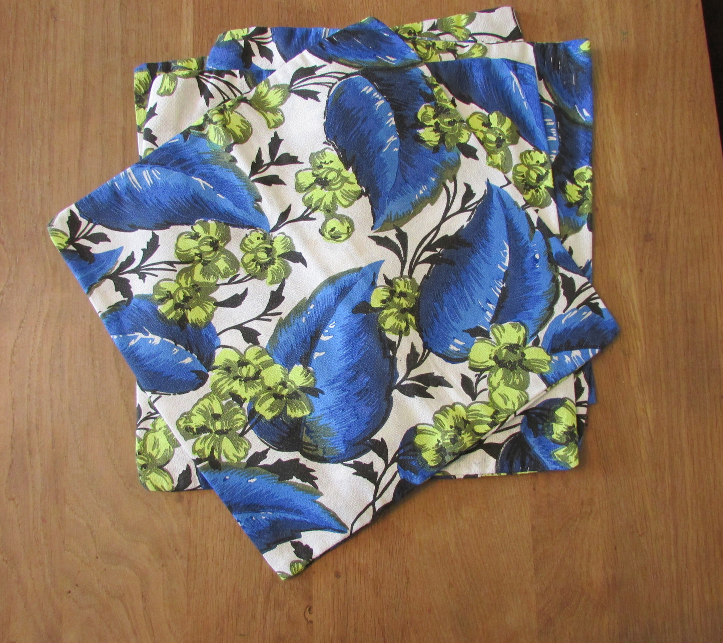 Home-made vintage bright blue leaf pattern cushion cover with same pattern reverse