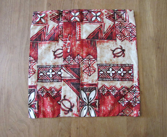Home-made vintage red Hawaiian-style/tiki pattern cushion cover with same pattern reverse
