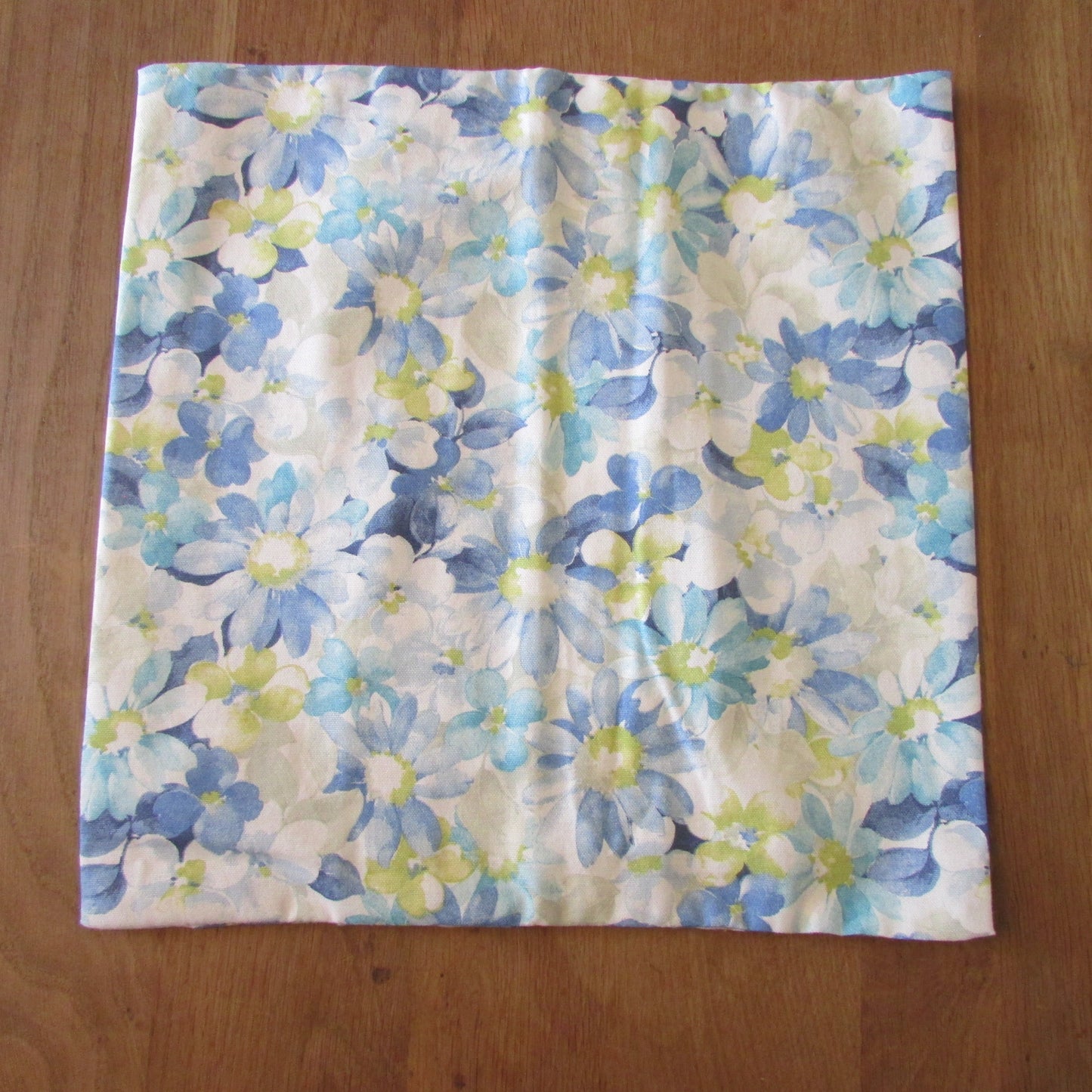 Home-made vintage pastel blues floral pattern cushion cover with same pattern reverse
