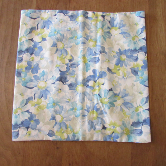 Home-made vintage pastel blues floral pattern cushion cover with same pattern reverse