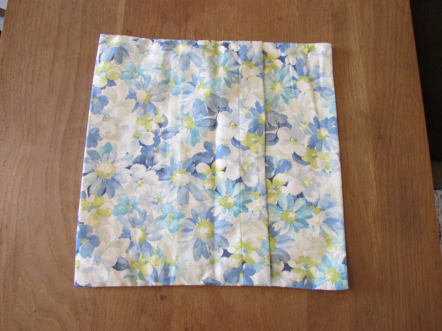 Home-made vintage pastel blues floral pattern cushion cover with same pattern reverse