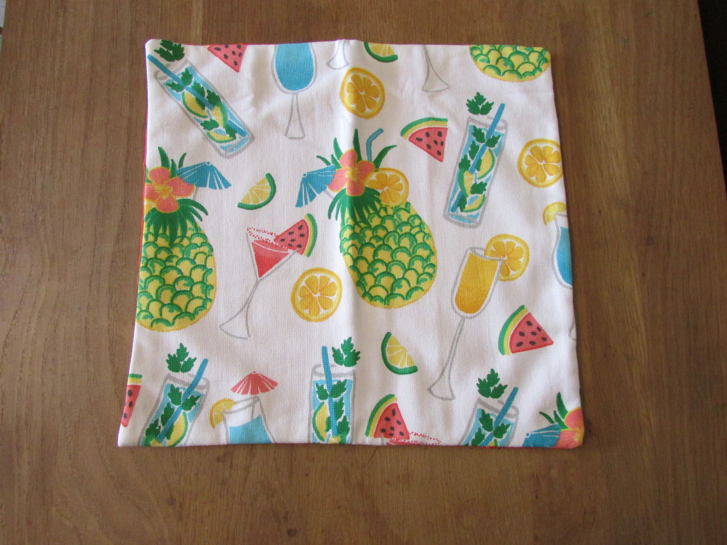 Home-made retro tropical cocktail print cushion cover with contrast orange reverse