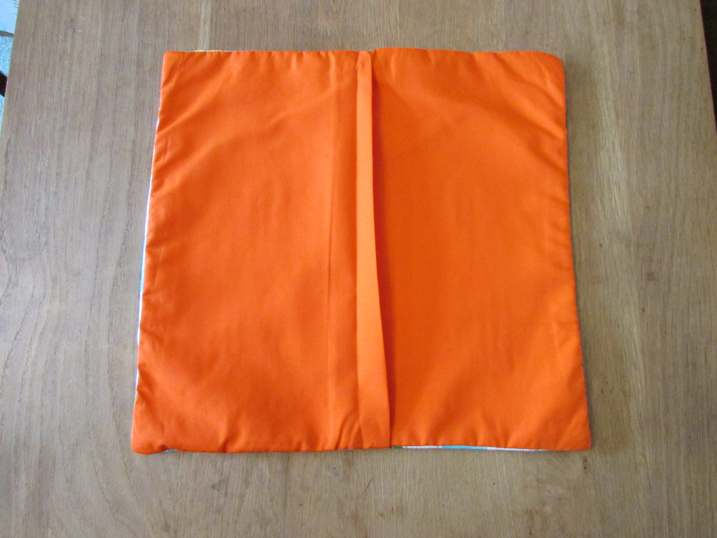 Home-made retro tropical cocktail print cushion cover with contrast orange reverse