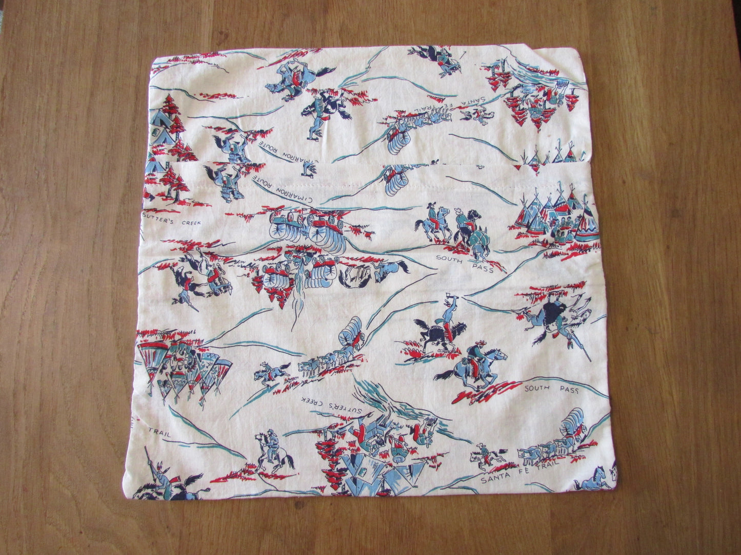 Home-made mid-century wagon trail/Wild West pattern cushion cover with same pattern reverse