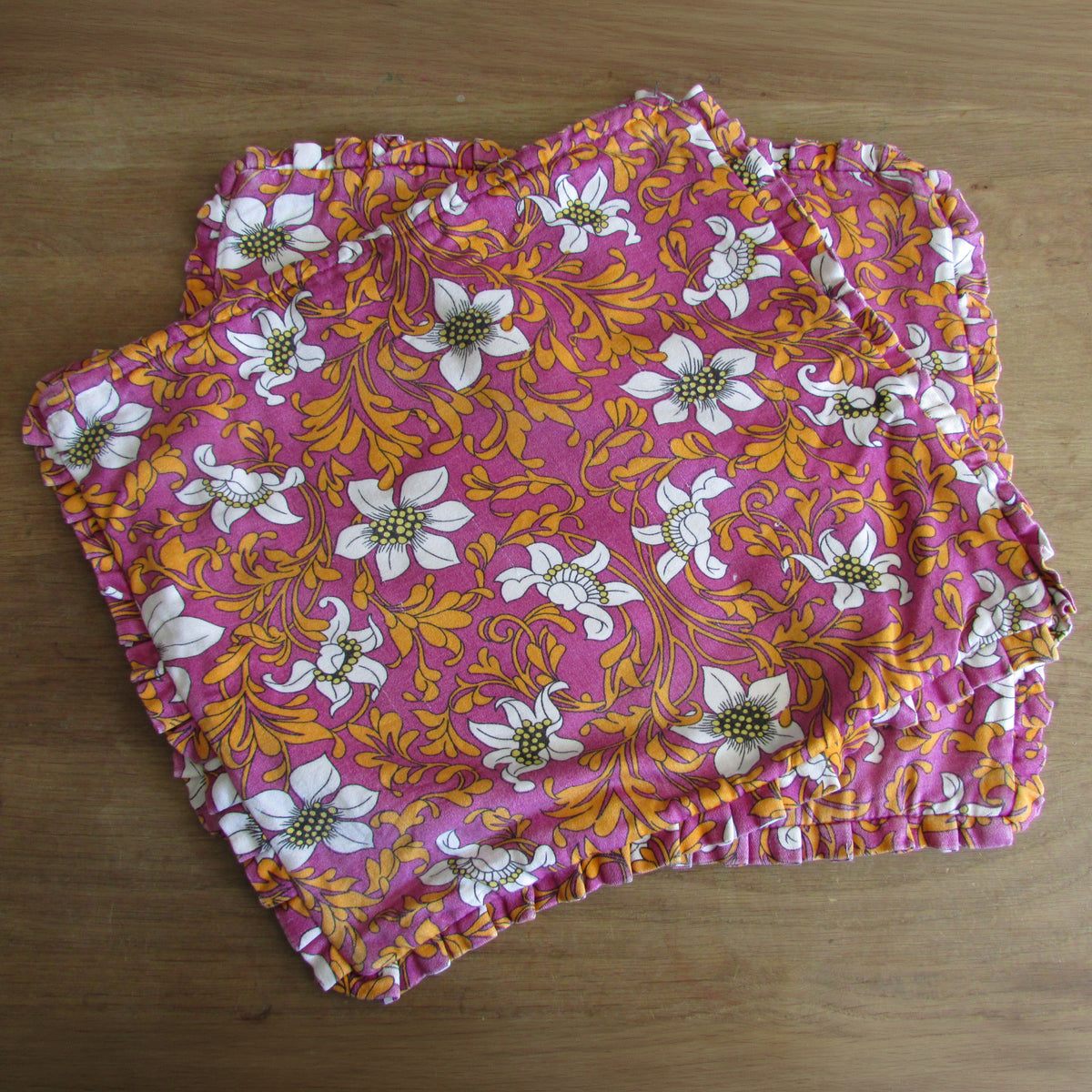 Pair of 1970s pink orange floral frilled cushion covers, 18" x 15"