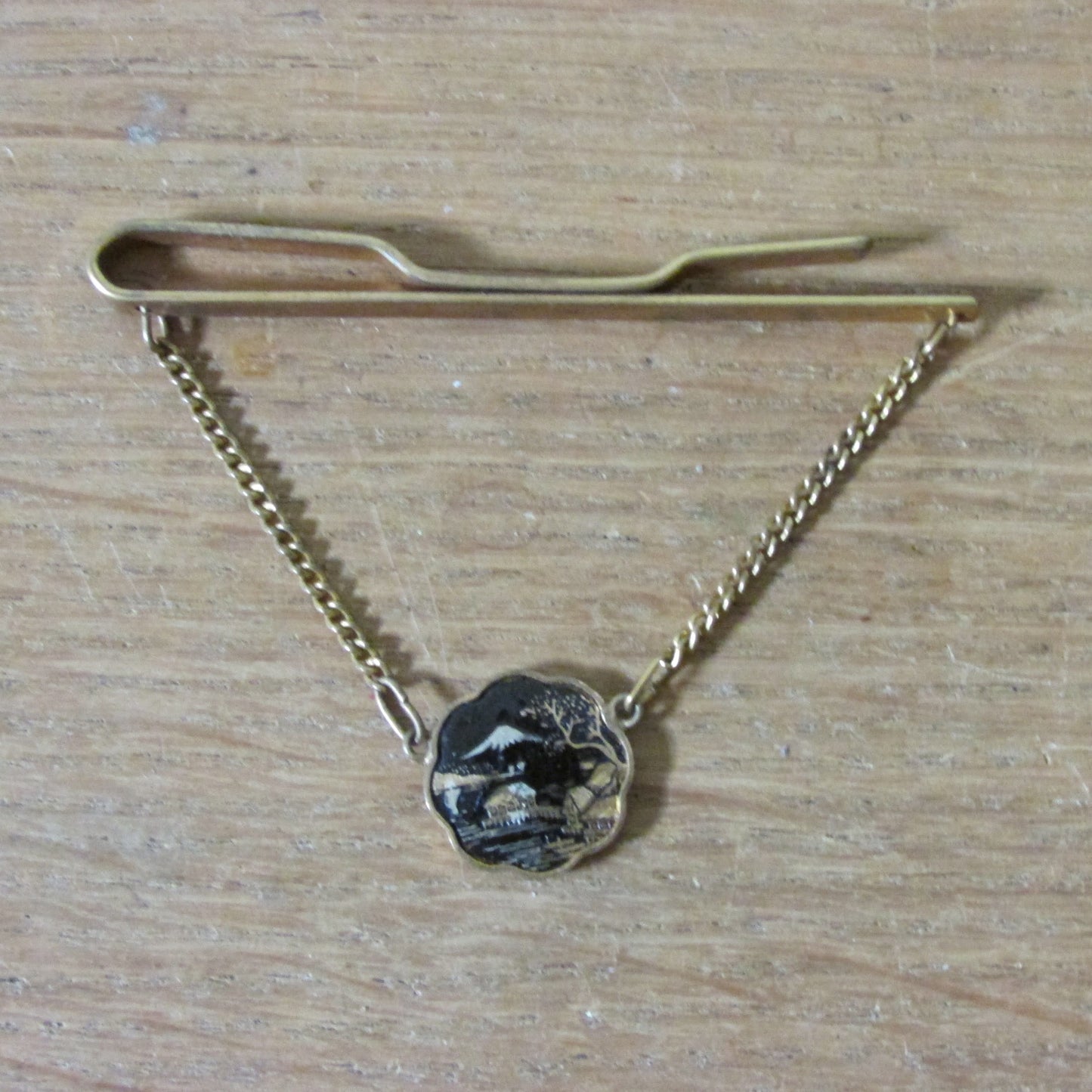 1960s gold-tone Damascene tie clip with hanging landscape medallion