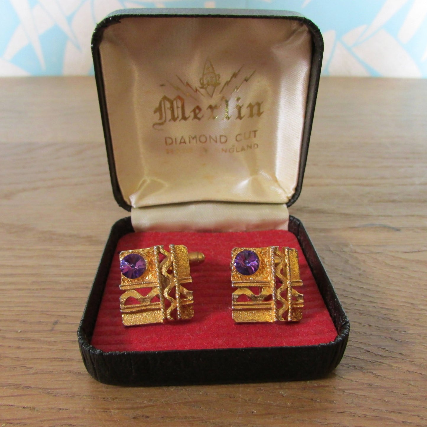 1960s Merlin diamond-cut gold-tone cufflinks with purple rhinestone detail