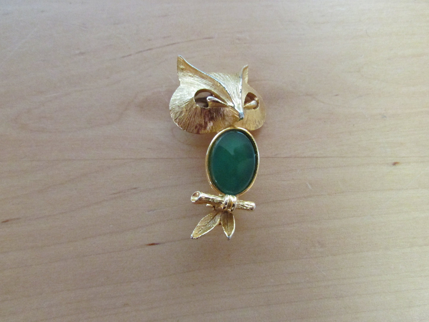 Vintage Liz Clairborne modernist-style gold-tone owl brooch with green cabochon belly