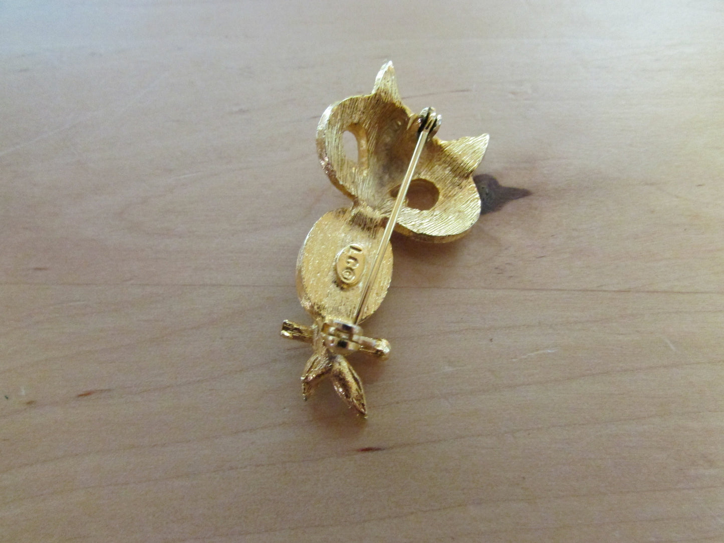 Vintage Liz Clairborne modernist-style gold-tone owl brooch with green cabochon belly