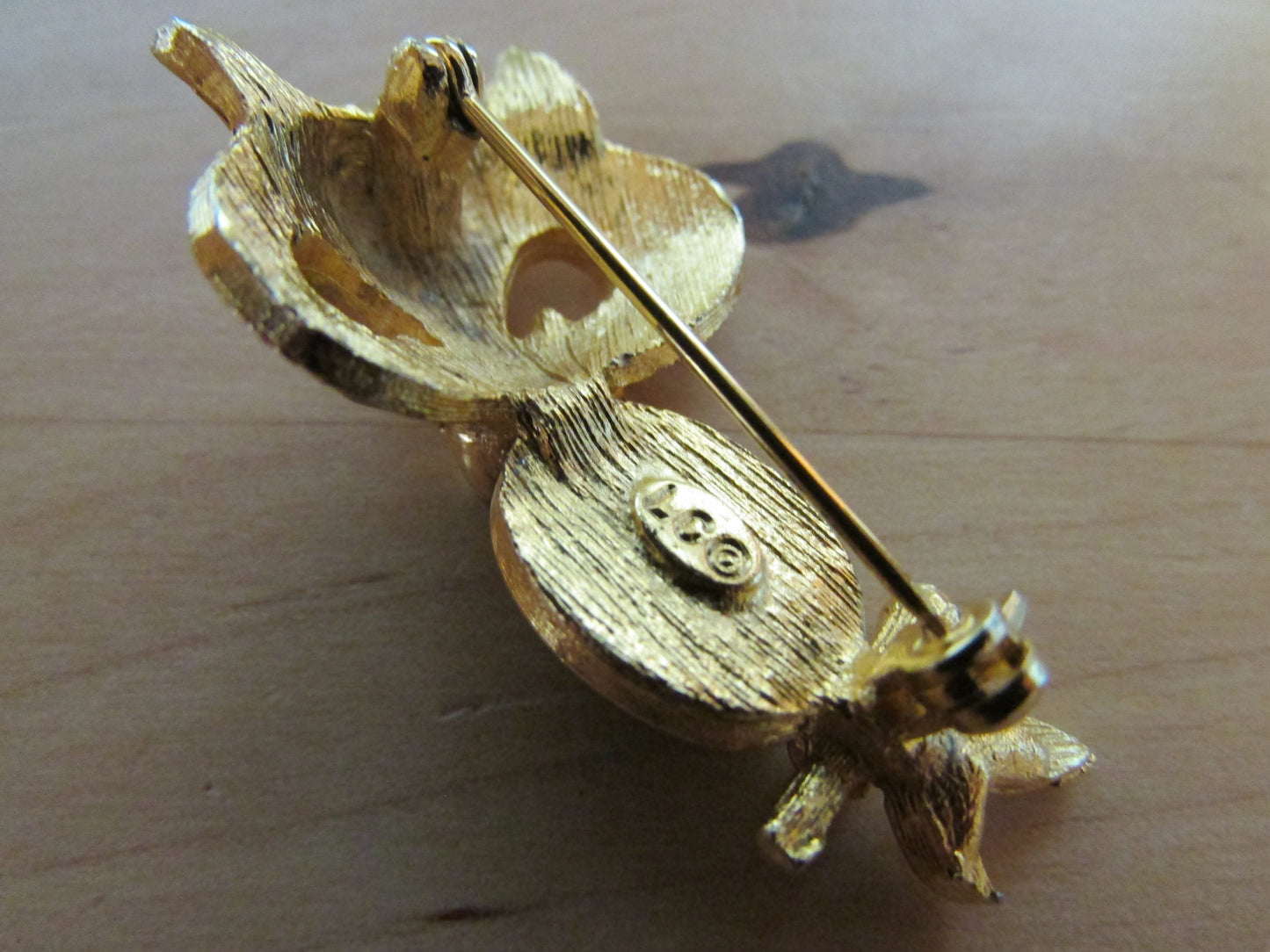 Vintage Liz Clairborne modernist-style gold-tone owl brooch with green cabochon belly