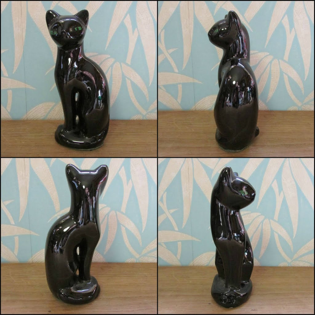 Pair of mid-century black ceramic mantel cats with green eyes