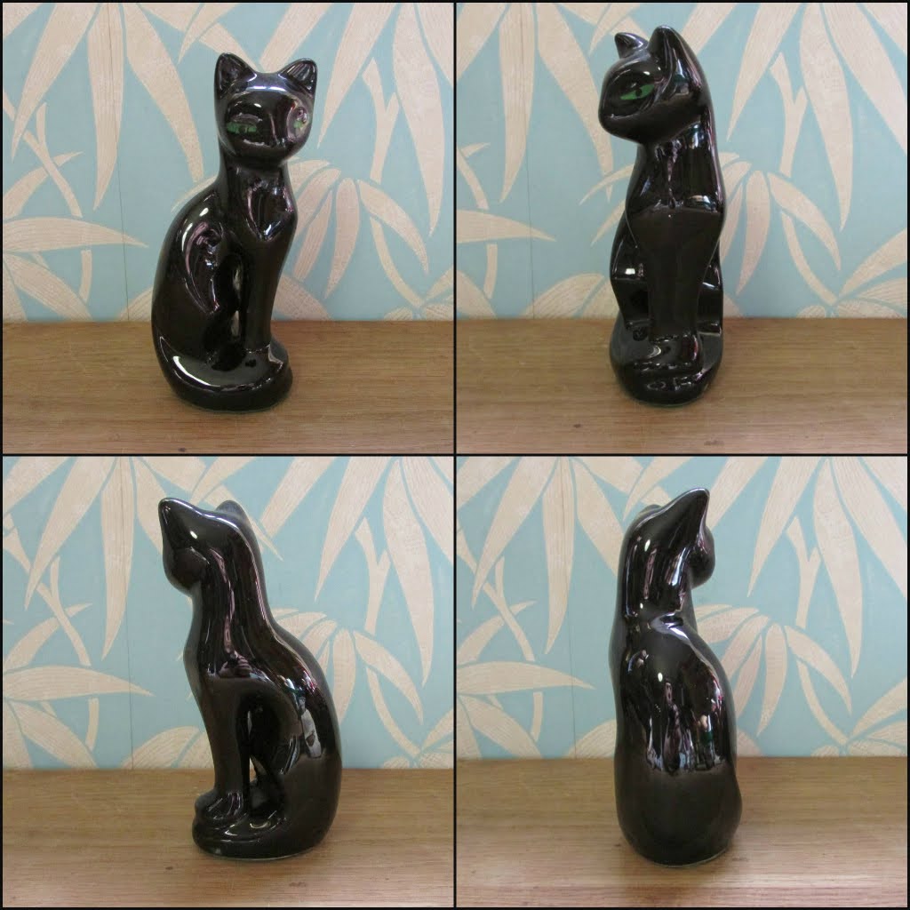 Pair of mid-century black ceramic mantel cats with green eyes