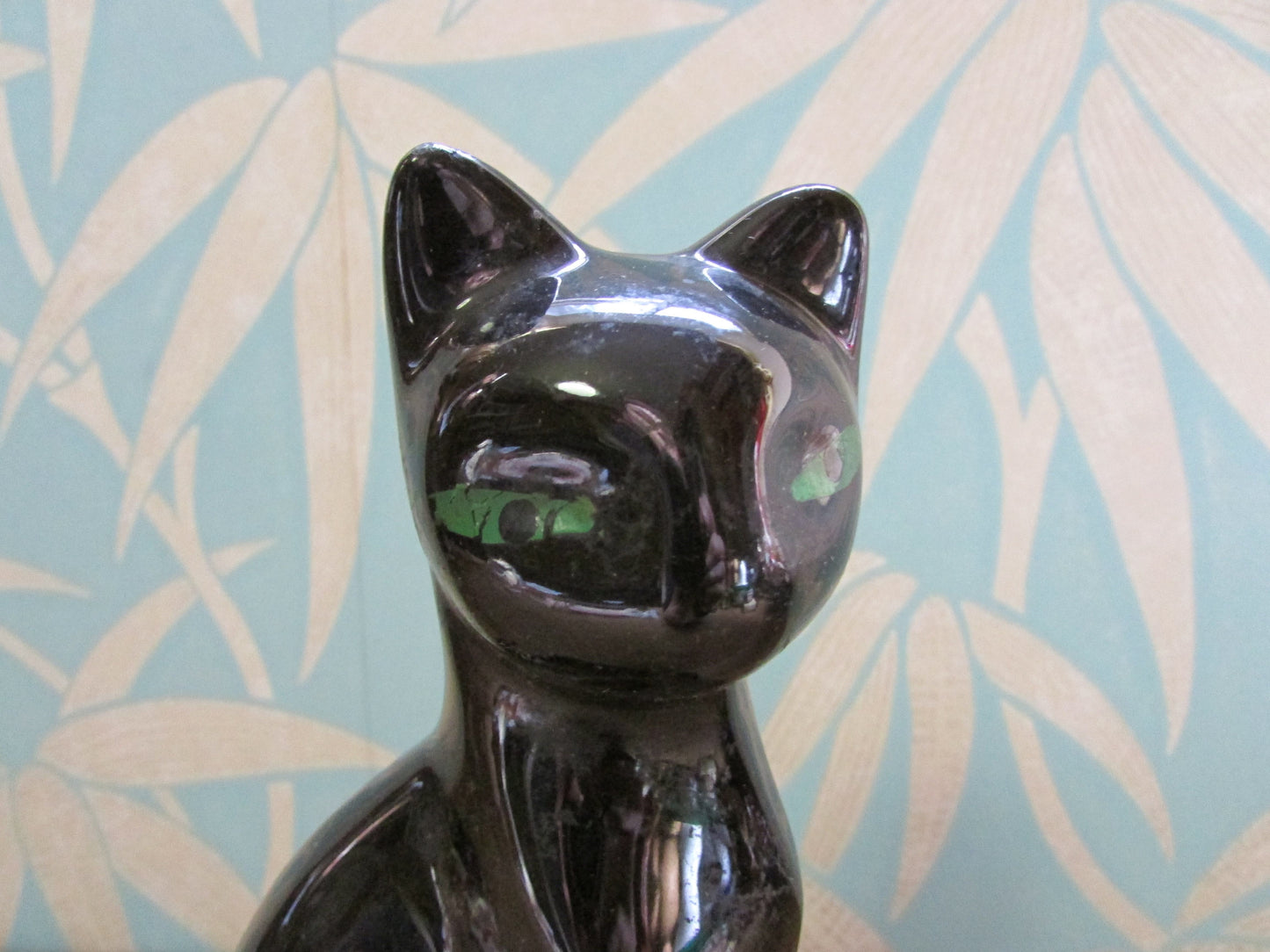 Pair of mid-century black ceramic mantel cats with green eyes