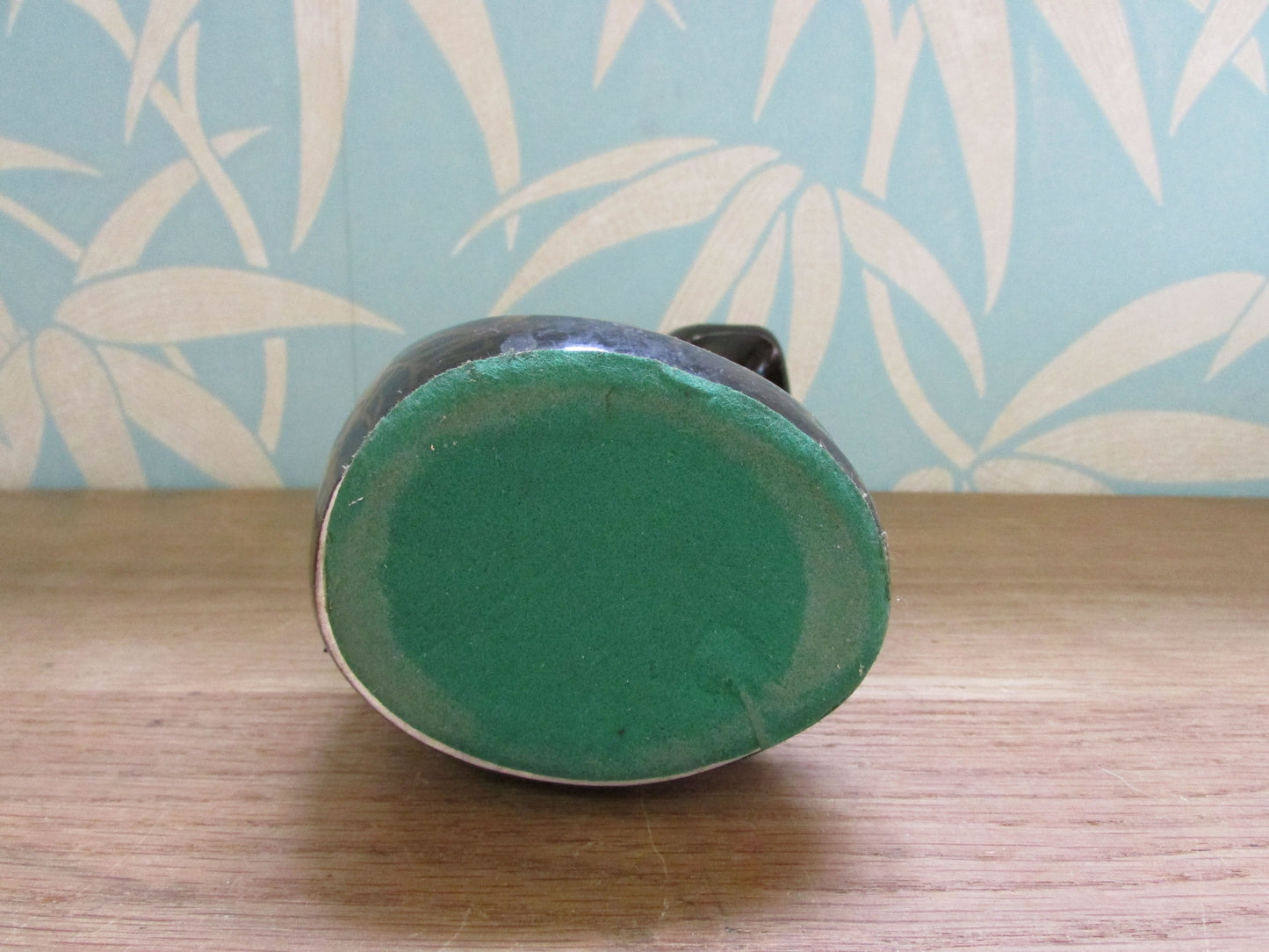 Pair of mid-century black ceramic mantel cats with green eyes