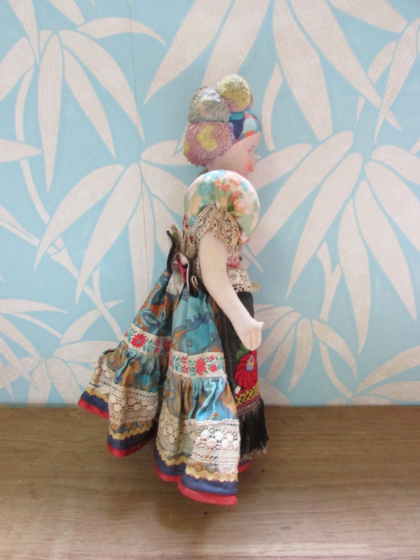 Vintage Hungarian folk art doll in traditional dress, with handpainted porcelain face, & cloth limbs