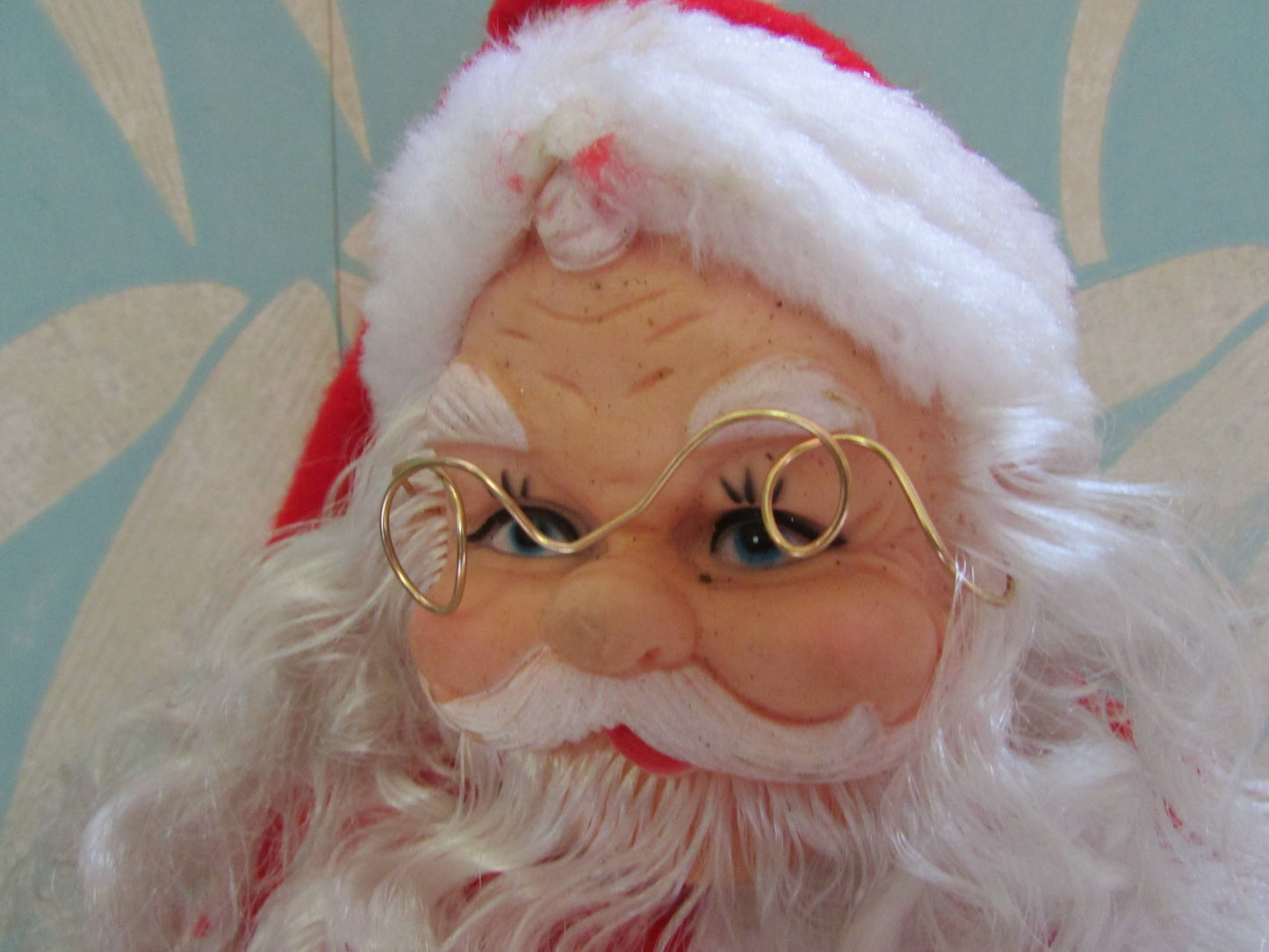 circa. 1980s hard plastic Santa Claus doll with wire spectacles