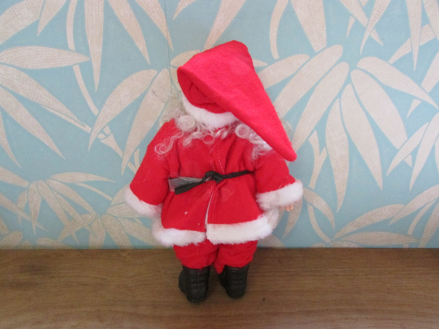 circa. 1980s hard plastic Santa Claus doll with wire spectacles